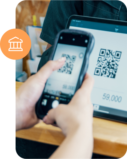 Zákazník skenuje QR kód na pokladně pomocí mobilu.